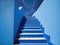 a blue staircase leading up to a blue building