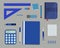 Blue stationery on a gray background. Top view of a desk