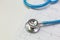 Blue stethoscopes and  Electrocardiography  chart close up image