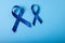 Blue stomach cancer awareness ribbons isolated on blue background, copy space