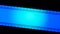 Blue strip of film, illuminated with circular light on black background close up. Cinema filmstrip on black background
