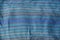 Blue striped texture of a cloth from a piece of crumpled clothes