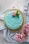 Blue stylish cake with flowers and mint on wooden box. Copy space, top view, flat lay food