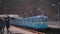 The blue subway train leaves the ground station on the bridge across the wide Dnieper River in Kiev.