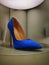 Blue suede high heel on display