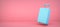 blue suitcase on pink background