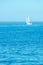 Blue summer seascape with distant yacht out of focus