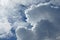 Blue summer sky with white cumulonimbus and altostratus clouds.