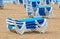 Blue Sun loungers stacked on a beach