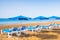 Blue sunbeds with umbrellas at sunny tropical beach in Lanzarote, Canary Islands