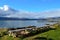 Blue sunny autumn fjord with park benches