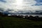 Blue sunny autumn fjord with park benches in front