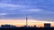 Blue sunrise and urban panorama with TV tower