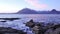 Blue sunset with snowy mountains of Soay island. Elgol beach coast, popular Scottish island Skye.