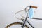 Blue surgical mask hanging from the handlebar of a vintage bike. Concept of new normality
