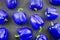 Blue sweet pepper on dark textile background , top view