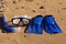 Blue Swim flippers, mask, snorkel for surf laing on the sandy beach. beach concept