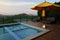 Blue swimming pool and brown sofa outdoor resort on mountain na