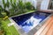 blue swimming pool with exotic wooden terrace in teak natural flooring and blue water