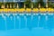 Blue swimming pool with yellow loungers