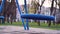 Blue swings on empty playground during COVID-19 pandemic