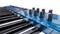 Blue synthesizer MIDI keyboard on white background. Synth keys close-up. 3d rendering