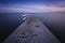 Blue t shirt on concrete jetty after sunset