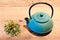 Blue teapot and chamomile plant