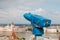 Blue telescope and blurred Budapest city on background