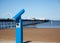 Blue telescope by blurred Southport pier