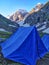 Blue tent in a campsite on a very pretty valley in Indian Himalayan Mountains. Hiking and camping on Hampta pass trek in India.