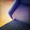Blue textile armchair and knitted carpet