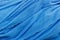 blue texture of fabric with wavy folds in close up image