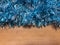 A blue tinsel on a wooden background