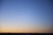 Blue to orange dark sunset sky over dessert landscape silhouette