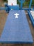 Blue tomb with a white cross in a cemetery