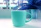 Blue tone colored pop art style coffee cup with the potted fern in the backdrop