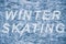 Blue tone ice texture. Skate marks on the ice. Winter outdoor skating. Text winter skating on ice surface.
