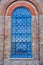 Blue Toned Stained Glass Window on Old Sandstone Church