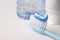 Blue toothpaste on a toothbrush on white background