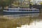 A blue tour restaurant boat moored on Regent`s canal in Camden Town