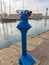 Blue tourist monocular for sightseeing on the background of yachts standing in the marina of the seaside town