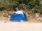 Blue tourist tent standing on the sandy beach