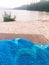 Blue towel in the foreground, with mountain beach in the background