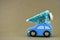 Blue toy car with a christmas tree on the roof. High resolution photo as a Christmas background.