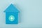 Blue toy house with target in the middle against blue background with copy space. Mortgage or loan concept