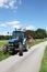 Blue Tractor And Hay Rake Summer Road