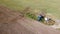 Blue tractor ploughing field