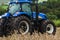 Blue tractor stopped on the mechanized soybean harvest