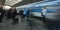 A blue train from Ceske Drahy arriving to the Prague main train station, with many passangers waiting to board the train